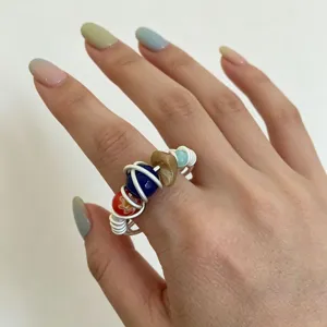 Handmade colorful beaded ring with unique white wire wrap, perfect detailed finger jewelry.