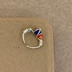 Handmade wire wrapped ring with colorful beads, detailed closeup view for women's fashion jewelry.