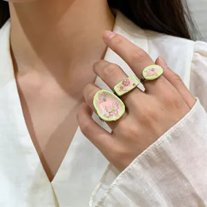 Handmade enamel Y2K style ring set featuring sweet pink and green butterfly and pearl details.