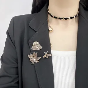 Vintage brooch set featuring elegant rhinestone hat leaf and bee pins for women jackets.