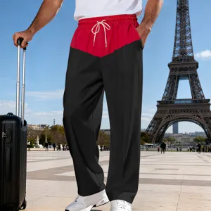 Detail shot of men's loose color block casual straight leg pants with drawstring waist in Paris.