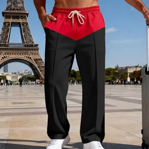 Outdoor detail shot of men's color-blocked loose straight casual pants with drawstring.