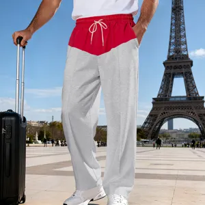 Detail view of casual color-blocked straight leg sweatpants with drawstring waist in outdoor setting.