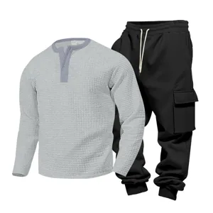 Detail view of men casual waffle long sleeve henley shirt and black cargo sweatpants set.