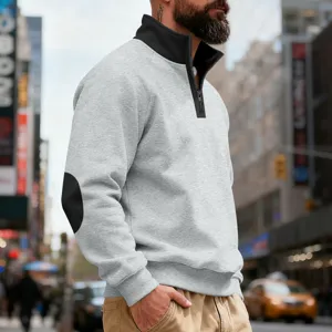 Detailed shot of men quarter-zip sweatshirt in light grey with black stand collar and elbow patch.
