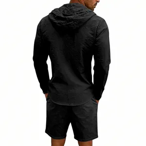 Detail view of black casual men's long sleeve hooded shirt and shorts set showing back fit.