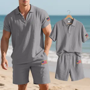 Detail view of men casual linen polo shirt and shorts set with flag embroidery at beach.