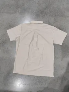 Back detail view of solid color short sleeve mens casual button down shirt in light khaki.