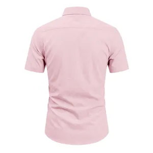 Classic men's short sleeve pink solid casual business dress shirt back view apparel detail.