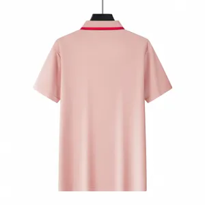 Men's short sleeve polo shirt in solid pink with red collar detail, casual and comfortable.