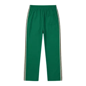 Pantalon de survêtement homme amples jogger droit vert avec bandes latérales contrastées.