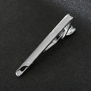Close-up view of a sleek silver metal tie clip, showcasing smooth polish and clasp detail.