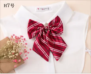 Red plaid bow tie for women uniform shirt, pre-tied ribbon collar accessory detail view.