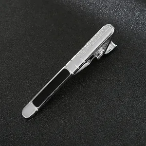 Men silver metal tie clip close-up, black accent elegant business suit accessory for formal wear.