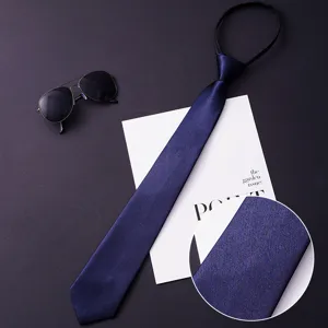 Men's zipper tie detail view showing the deep blue silky textured fabric and fine weave.