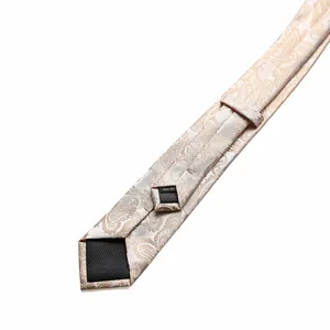 Close-up detail of champagne gold paisley necktie back side, showing fine handmade craftsmanship.