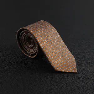 Detailed closeup shot of a rolled men's brown patterned vintage business formal necktie.