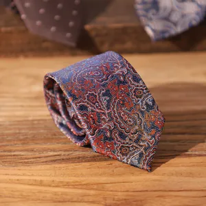 Classic paisley pattern men's necktie in navy blue with orange details, ideal for formal wear.