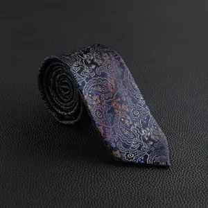 Detailed view of luxury men's vintage paisley tie in navy blue with elegant gold pattern.