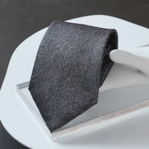Close-up detail of a premium dark grey textured business necktie for formal suits.