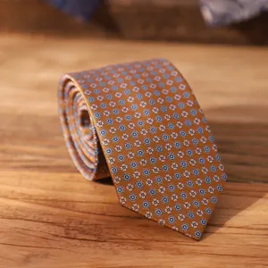 Close-up detail of a vintage patterned silk necktie featuring intricate geometric motifs.