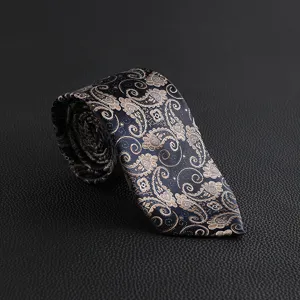 Luxury men tie detail shot, vintage paisley floral pattern on dark blue fabric texture.