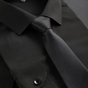 Mens black business formal shirt and striped tie detail view high quality fabric.
