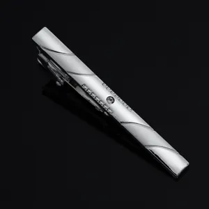 Detailed close-up of a stylish silver men's tie clip with crystal accent and elegant diagonal lines.