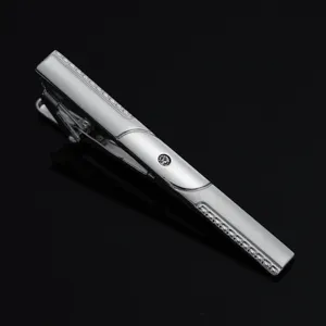 Close-up detail shot of a sleek silver men's tie clip featuring a sparkling crystal accent.