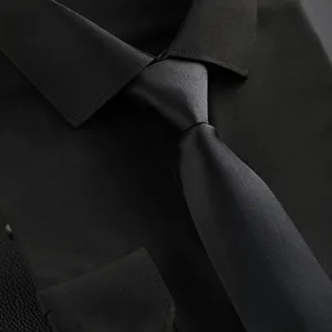 Classic black business shirt and tie detail view, elegant men's formal wear for professional use.