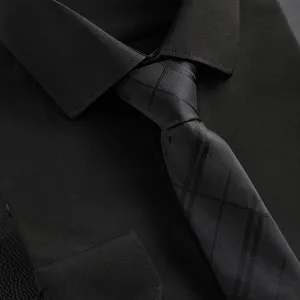Men's black business dress shirt and elegant patterned tie for formal wear events.
