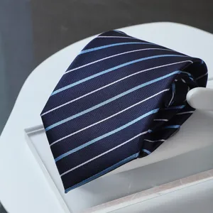 Close-up of a dark blue formal business tie with elegant white and light blue diagonal stripes.