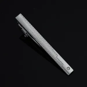 Silver metal tie clip detail, geometric engraved pattern, crystal rhinestone accent, business wear.
