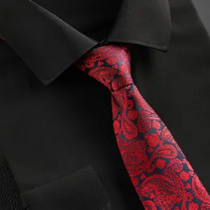 Detailed shot of men's elegant red and blue paisley tie paired with a black dress shirt.
