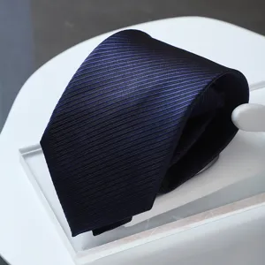 Detailed close-up shot of a dark blue striped necktie showing exquisite woven texture.