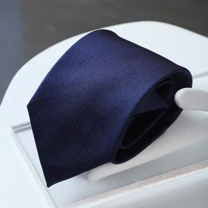 Detailed close-up view of a dark blue twill fabric men's formal business tie neatly displayed.