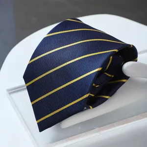 Closeup detail shot of a premium navy blue tie featuring elegant yellow diagonal stripes.