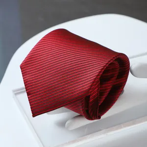 Detailed close-up view of elegant red and black striped tie fabric texture and pattern.