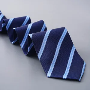 Close-up detail of the classic navy blue necktie featuring crisp light blue diagonal stripes.