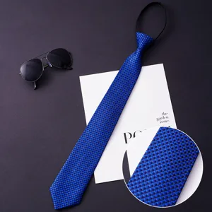 Blue zipper tie close-up showing fine woven texture, perfect suit accessory detail shot.