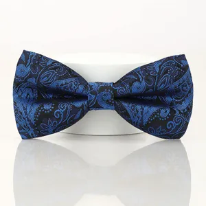 Blue and black paisley bow tie for men, classic British style wedding accessory detail.