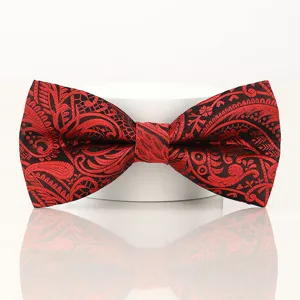 Red black paisley pattern men bow tie fabric detail close up shot for wedding groom.