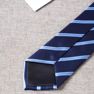 Detail shot of navy blue striped men's tie, showing fine fabric texture and lining.