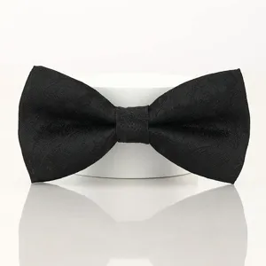 Close-up detail view of classic black men's bow tie with subtle jacquard pattern texture.