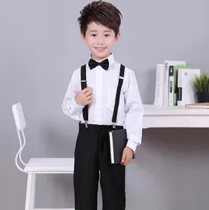 Vue détaillée de la tenue de cérémonie pour enfants chemise blanche pantalon noir et nœud papillon.