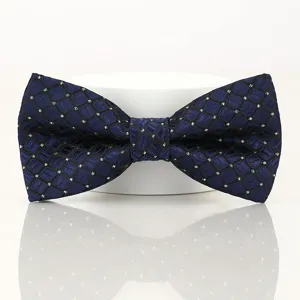 Detail shot of a classic men's blue geometric patterned bow tie on a display stand.