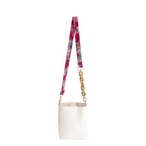 Wit emmertje tas detail met unieke roze bloemen jacquard webbing en dikke gouden ketting.