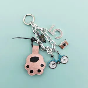 Cute cartoon cat paw keychain with camera bicycle and number 5 charms for women bag charm.