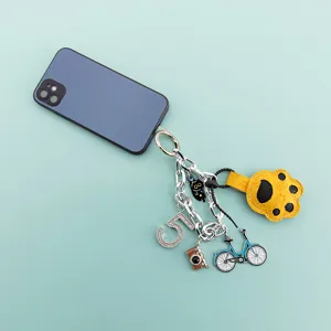 Cute cat paw keychain phone strap pendant with camera, bicycle and crystal number charms.