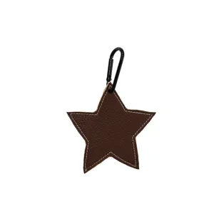 Close-up detail of brown star leather bag charm with white stitching and black metal carabiner.